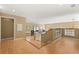 Open concept living space with wood floors and a staircase featuring wrought iron railings at 9128 Phillips Grove Ter, Orlando, FL 32836