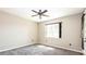 Bedroom featuring neutral paint and carpet, a window and a ceiling fan at 922 Suffolk Pl, Davenport, FL 33896