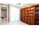 Bedroom features a large built-in wooden bookcase, closet, ceiling fan, and light floors at 922 Suffolk Pl, Davenport, FL 33896