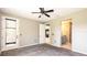 Spacious bedroom featuring a ceiling fan, carpet flooring, and access to the bathroom and walk-in closet at 922 Suffolk Pl, Davenport, FL 33896