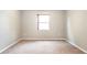This cozy bedroom features soft carpet, neutral walls, and a bright window at 922 Suffolk Pl, Davenport, FL 33896