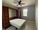 Bedroom features a Murphy bed, a window with natural light and a ceiling fan at 922 Suffolk Pl, Davenport, FL 33896