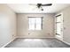 Bedroom with carpet, bright window, ceiling fan and door to outside at 922 Suffolk Pl, Davenport, FL 33896