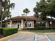 Exterior of clubhouse featuring tan paint, white columns, and well-kept landscaping at 922 Suffolk Pl, Davenport, FL 33896