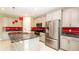 Modern kitchen boasts stainless steel appliances, granite counters, and red backsplash at 922 Suffolk Pl, Davenport, FL 33896