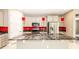 Stylish kitchen featuring granite countertops, stainless steel appliances, and red backsplash at 922 Suffolk Pl, Davenport, FL 33896