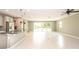 Bright open-concept space with tile flooring and sliding glass doors leading to the backyard at 922 Suffolk Pl, Davenport, FL 33896