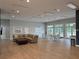 A cozy lounge area with a large sectional couch, dining table and chairs and ample natural light at 922 Suffolk Pl, Davenport, FL 33896