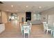 A large lounge area with dining tables and chairs, a fireplace, and laminate floors at 922 Suffolk Pl, Davenport, FL 33896