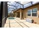 Relaxing screened patio featuring a splash pool and ample space for seating at 922 Suffolk Pl, Davenport, FL 33896