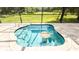 Close-up view of a splash pool featuring mosaic tile details and a tranquil backyard at 922 Suffolk Pl, Davenport, FL 33896