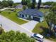Aerial view of a well maintained home with a large driveway, and manicured lawn in a Florida community at 1006 Linkside Ct, Apopka, FL 32712