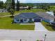 A home with a new roof, gray brick driveway and walkway, and green lawn in a sunny community at 1006 Linkside Ct, Apopka, FL 32712