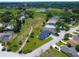 An aerial view of a home with new roof, driveway, landscaping, and a large greenbelt in the background at 1006 Linkside Ct, Apopka, FL 32712