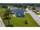 Aerial view of a house showcasing well-manicured landscaping and modern exterior finishes and new roof at 1006 Linkside Ct, Apopka, FL 32712