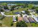 An aerial view of a community showcasing many homes, greenbelts, and a pond in the distance at 1006 Linkside Ct, Apopka, FL 32712