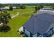 An aerial shot displays the dark roof, exterior, and nearby grassy area of a home at 1006 Linkside Ct, Apopka, FL 32712