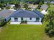 Aerial view of a home's backyard featuring a well-manicured lawn, patio, and modern exterior at 1006 Linkside Ct, Apopka, FL 32712