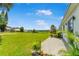 Expansive backyard view featuring a lush green lawn, beautiful landscaping, and open space at 1006 Linkside Ct, Apopka, FL 32712