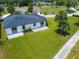 Aerial view showcasing a home's backyard with lush green grass and a neutral-colored exterior at 1006 Linkside Ct, Apopka, FL 32712