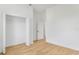 Bedroom featuring wood floors, a closet, and access to other rooms for easy living at 1006 Linkside Ct, Apopka, FL 32712