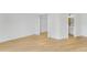 Bright bedroom with light wood floors and open door to the bathroom at 1006 Linkside Ct, Apopka, FL 32712