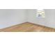 Bedroom showcasing wood flooring, a window for natural light, and a simple layout at 1006 Linkside Ct, Apopka, FL 32712