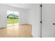 Bright bedroom featuring light wood flooring and a sliding glass door to the outside at 1006 Linkside Ct, Apopka, FL 32712
