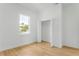 Bright bedroom showcasing a window, wood floors, and a closet for storage and organization at 1006 Linkside Ct, Apopka, FL 32712