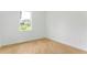 Bedroom featuring wood floors, a window for natural light, and a simple layout at 1006 Linkside Ct, Apopka, FL 32712