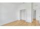 Spacious bedroom with bi-fold closet doors, wood flooring, and natural light from window at 1006 Linkside Ct, Apopka, FL 32712