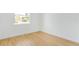Empty bedroom with a window offering natural light, wood floors, and clean, white walls at 1006 Linkside Ct, Apopka, FL 32712