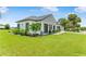 Landscaped lawn of single-story home with dark shutters and an attached two-car garage at 1006 Linkside Ct, Apopka, FL 32712