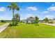 Expansive front yard of home with lush landscaping and mature palm trees, and a long driveway at 1006 Linkside Ct, Apopka, FL 32712