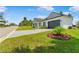 Well-maintained front yard featuring a single-story home, beautiful landscaping, and an attached two-car garage at 1006 Linkside Ct, Apopka, FL 32712