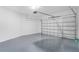 View of a modern two car garage with epoxy flooring and garage door opener at 1006 Linkside Ct, Apopka, FL 32712