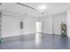 View of a modern two car garage with epoxy flooring and garage door opener at 1006 Linkside Ct, Apopka, FL 32712
