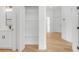 Hallway with wood flooring, walk in closet, and access to different areas of the house at 1006 Linkside Ct, Apopka, FL 32712