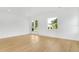 Open living room showcasing wood-look floors, fresh paint, and windows at 1006 Linkside Ct, Apopka, FL 32712