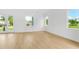 Bright living room featuring sleek floors, fresh paint, and windows at 1006 Linkside Ct, Apopka, FL 32712