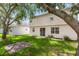 Backyard featuring a grassy area, mature tree, and a brick patio perfect for outdoor enjoyment at 10299 Cypress Knee Cir, Orlando, FL 32825