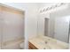 Bathroom featuring a tub/shower combination with tile surround and a large mirror at 10299 Cypress Knee Cir, Orlando, FL 32825