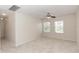 Spacious bedroom with two windows, carpet, and ceiling fan at 10299 Cypress Knee Cir, Orlando, FL 32825