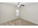 Carpeted bedroom featuring a ceiling fan and a window at 10299 Cypress Knee Cir, Orlando, FL 32825