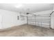 Spacious two car garage with automatic door, concrete floor, and bright lighting at 10299 Cypress Knee Cir, Orlando, FL 32825
