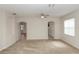 Bright living room featuring neutral carpeting, arched entryways, and a ceiling fan providing modern comfort at 10299 Cypress Knee Cir, Orlando, FL 32825