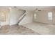 Open-concept living space connects living and dining areas, with stairs to the upper level and large windows at 10299 Cypress Knee Cir, Orlando, FL 32825