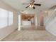 Open-concept space showcasing living room and kitchen, carpeted floors, and sliding door to the back yard at 10299 Cypress Knee Cir, Orlando, FL 32825