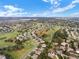 Aerial view of a residential community featuring mature landscaping, golf course and stunning views at 1097 Harmony Ln, Clermont, FL 34711