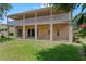 Two-story home with an expansive outdoor balcony, columns, sliding doors and a well-maintained lawn at 1097 Harmony Ln, Clermont, FL 34711